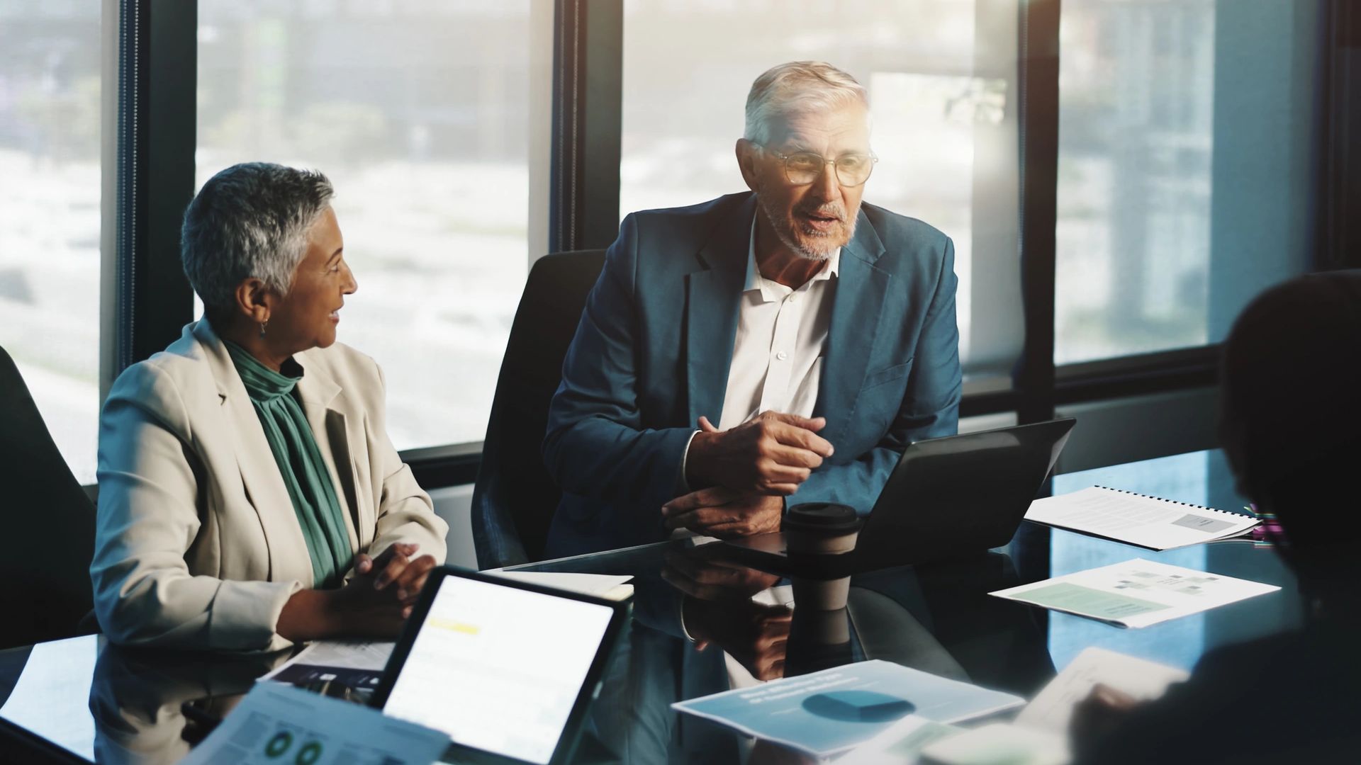 Professionals discussing business strategy around a meeting table